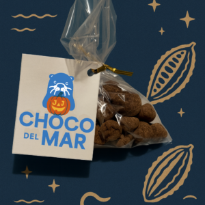 A stylized photo of a bag of chocolates. there is an attached card with the choco del mar logo holding a pumpkin.